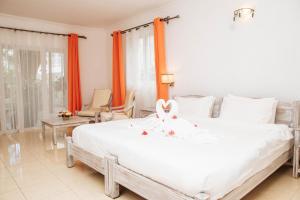 Кровать или кровати в номере Hibiscus Boutique Hotel