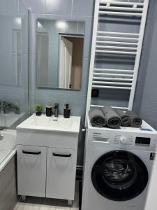 a bathroom with a washing machine and a sink at Apartments in Bălţi