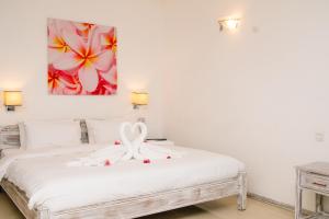 Кровать или кровати в номере Hibiscus Boutique Hotel
