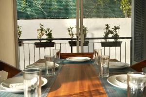 a wooden table with plates and glasses on it at Aqua Reef Condos Sayulita Apt 2 in Sayulita