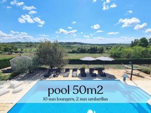 a swimming pool with chairs and umbrellas in a yard at Spacious villa with pool, indoor jacuzzi and sauna near Poreč in Višnjan +42 photos