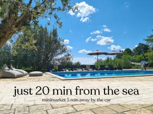 a picture of a swimming pool with the text just min from the sea at Spacious villa with pool, indoor jacuzzi and sauna near Poreč in Višnjan