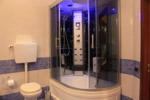 a bathroom with a glass shower with a toilet at B&B Del Corso in Naples