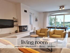 a living room with a couch and a tv at Spacious villa with pool, indoor jacuzzi and sauna near Poreč in Višnjan