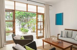 a living room with a couch and a table at Kisiwa on the Beach in Paje