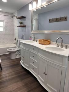 une salle de bain avec deux lavabos et un WC et un miroir dans l'établissement The Mark at Surfside #12 HOT TUB!, à Surfside Beach