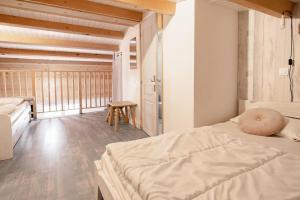 a bedroom with a bed with a pillow on it at Rare, Triplex 12 personnes, accès direct ski aux pieds in Les Deux Alpes