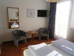 A bed or beds in a room at Pension & Apartments Ertl