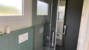 ein Badezimmer mit Dusche mit Glastür in der Unterkunft Agriturismo La Palazzina in Castelnuovo del Garda