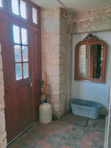 a bathroom with a tub and a window and a door at maison familiale au cœur du cotentin in Valognes