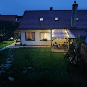a house with a solar panel on the yard at Połoninka Pokoje in Ustrzyki Górne +15 photos