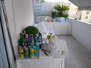 a group of tables with bottles and glasses on a balcony at Acropolis View Studio in Monastiraki in Athens +28 photos