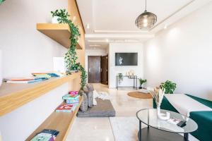 a living room with a couch and a table at City Hideaway Suite - TGV Station & Beach Walk in Tangier
