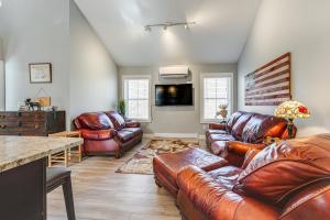 a living room with leather furniture and a table at Ski, Hike and Boat Modern Bridgton Retreat in Bridgton