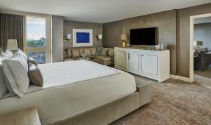 
a hotel room with two beds and a television at L'Ermitage Beverly Hills in Los Angeles
