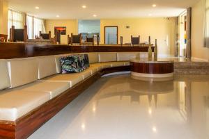 a lobby with a long couch in a building at Sunset Beach Taíba Hotel in Taíba +85 photos