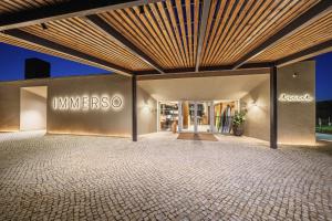 a store front with a sign on the wall at Immerso Hotel, a Member of Design Hotels in Ericeira