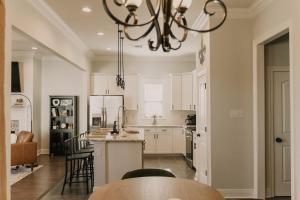 a kitchen with a table and chairs and a chandelier at Long Term Stay Fast Wifi Comfortable in Lake Charles