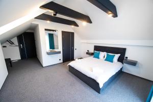 a bedroom with a large bed with blue pillows at Royal Wood Hotel in Rokytne +47 photos