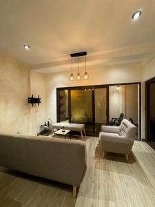 a living room with a couch and chairs and a table at Suite Boutique #5 Antigua Guatemala in San Pedro Las Huertas