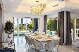 a dining room with a table and chairs at Waterfront Villa at Al Hamra with swimming pool in Ras al Khaimah