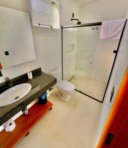 a bathroom with a toilet and a sink and a shower at Cabana Mendoza - Busch Camping in Rancho Queimado