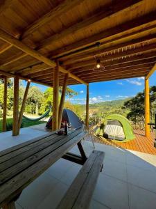 a picnic table and two tents on a patio at Cabana Mendoza - Busch Camping in Rancho Queimado