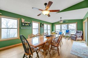 a dining room with green walls and a table and chairs at Easton Hills in Spicer