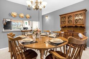 ein Esszimmer mit einem Holztisch und Stühlen in der Unterkunft Golfer's Paradise Ventura Resort Luxury Condo in Orlando