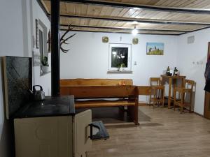 a living room with a bench and a table at Drago Kremenjaš in Delnice