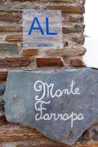 un cartello sul lato di un muro di mattoni di Monte Farropo a Monsaraz