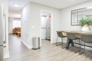 a kitchen and dining room with a table and chairs at Modern Townhome Walk to Tennessee Tech University in Cookeville