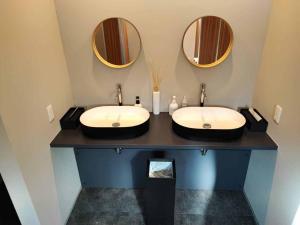 a bathroom with two sinks and two mirrors at GRAN TOCORO, RESORT&GLAMPING - Vacation STAY 53426v in Narusawa