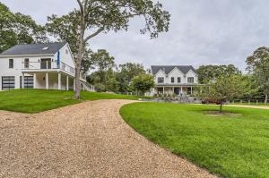 a large white house with a tree and a driveway at Vineyard Haven Retreat With Pool & Guest House Oasis in Big Rock