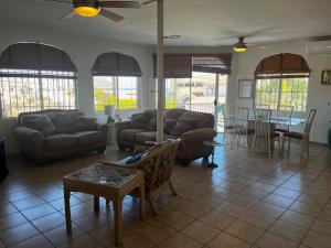 a living room with two couches and a table at Casa Keka Triplex in Playas of San Felipe! in San Felipe