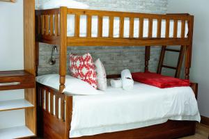 a bedroom with two bunk beds with red and white pillows at Crisp Guest Rooms in Bloemfontein