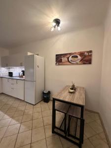 a kitchen with a table and a refrigerator at Cozy 2-Bedroom Retreat Near Subway and City Center in Vienna +14 photos