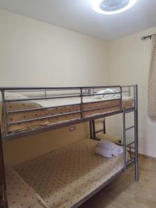two bunk beds in a room with a ceiling at Alojamiento el camarín in Baños de la Encina