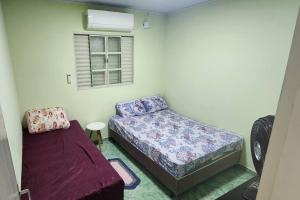 En eller flere senge i et værelse på Casa Completa e Independente