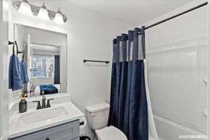 a bathroom with a sink and a toilet and a shower at Cozy Eagle River Retreat in Eagle River +7 photos