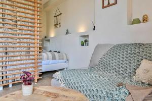 a living room with a couch and a bed at Mon petit cocon au bord de l'eau in La Ciotat