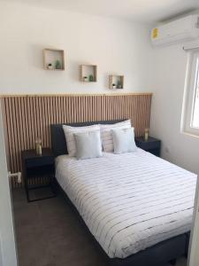 a bedroom with a large bed with two night stands at Modern Appartement Noord Jan Thiel #2 in Willemstad