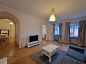 a living room with a couch and a tv at Home Inn Rör11 in Stockholm