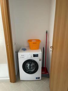 a washing machine with a basket on top of it at Affittacamere Da Maria 3 in Albiano