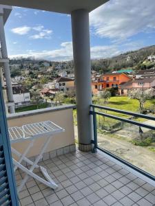 a balcony with a table and a view of a city at Affittacamere Da Maria 3 in Albiano +13 photos