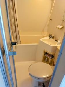a small bathroom with a toilet and a sink at Orange House - Vacation STAY 45376v in Shimoda