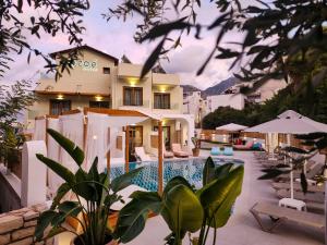 a villa with a swimming pool in front of a house at Zoe Boutique Hotel in Bali