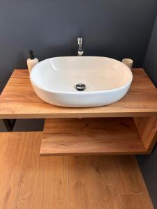 a white sink on a wooden counter in a bathroom at Casa Matilde in Sanremo +16 photos