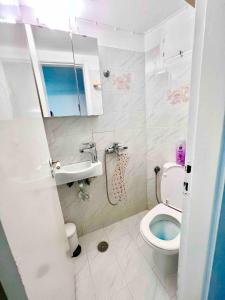 a small bathroom with a toilet and a sink at Sunset Suite - Center of Mykonos in Mýkonos City
