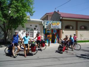 people riding bikes down a street at Art Hostel in Tashkent